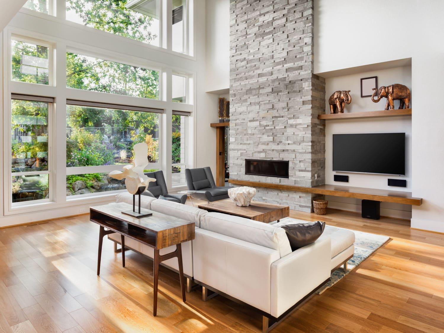 Beautiful living room interior with hardwood floors and fireplace in new luxury home