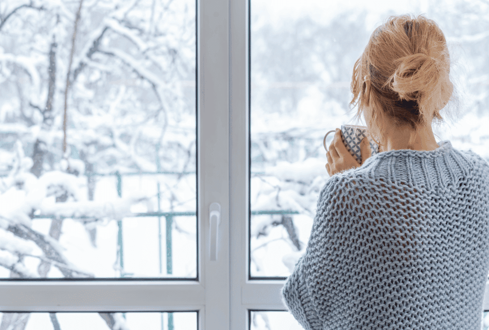 woman standing in front of window